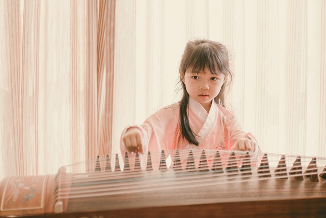 A young child playing the Chinese zither.
