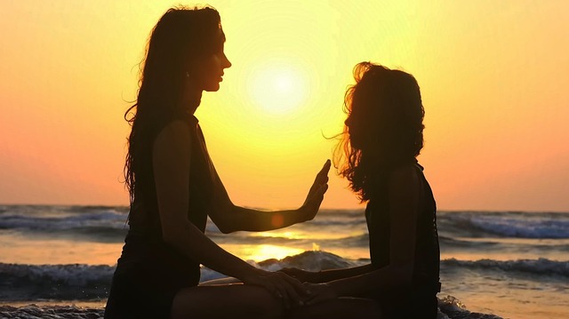 A woman channeling healing energy to another woman.