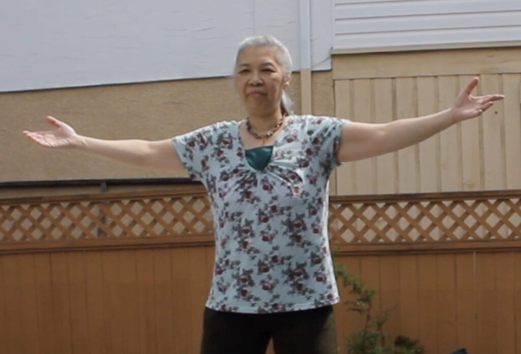 Practitioner performing Wild Goose Qigong heart health outdoors